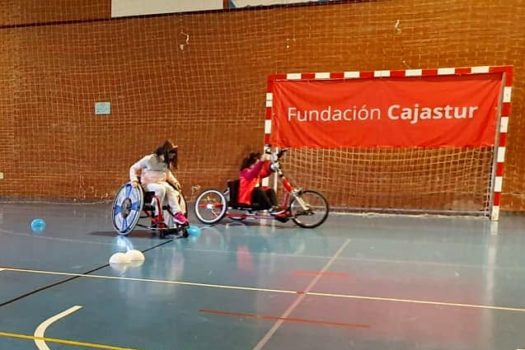 Dos niñas practicando entre conos con sillas de ruedas